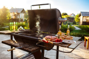Peerless - Backyard grill with food and drinks.